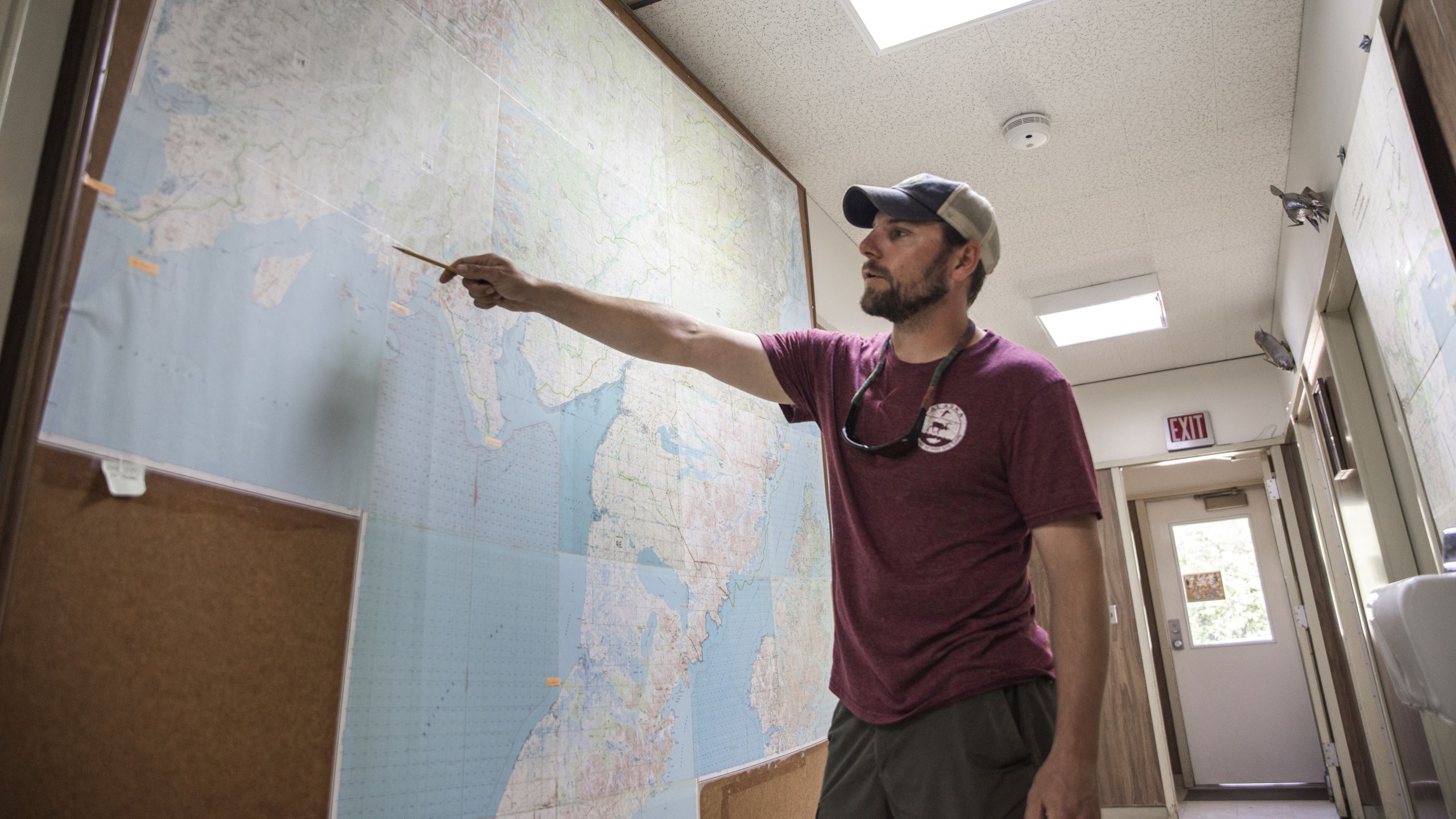 A man pointing to Bristol Bay on a map